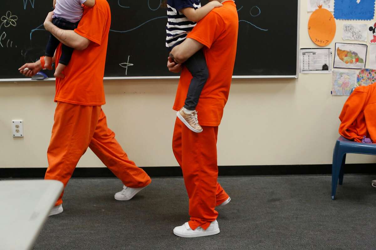 Inmates at County Jail #5 carry their children as they visit with them during a Community Works One Family visit on Saturday, June 4, 2016 in San Francisco, California.