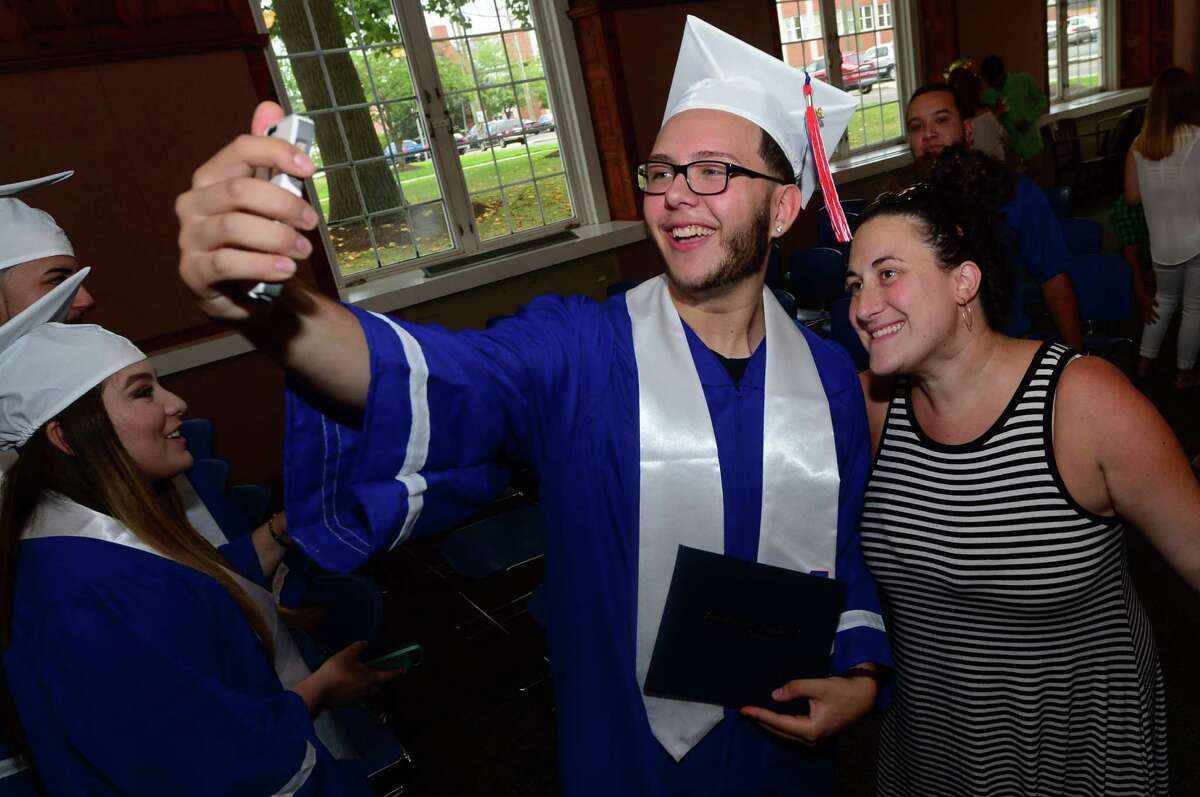 Brien McMahon High School senior Eric Vento celebrates with his English teacher, Sarah Molinelli, as students from both high schools receive their diplomas during the Norwalk Public School's summer school program graduation exercises for the Class of 2016 at the City Hall Community Room in Norwalk on Tuesday, Aug. 2.
