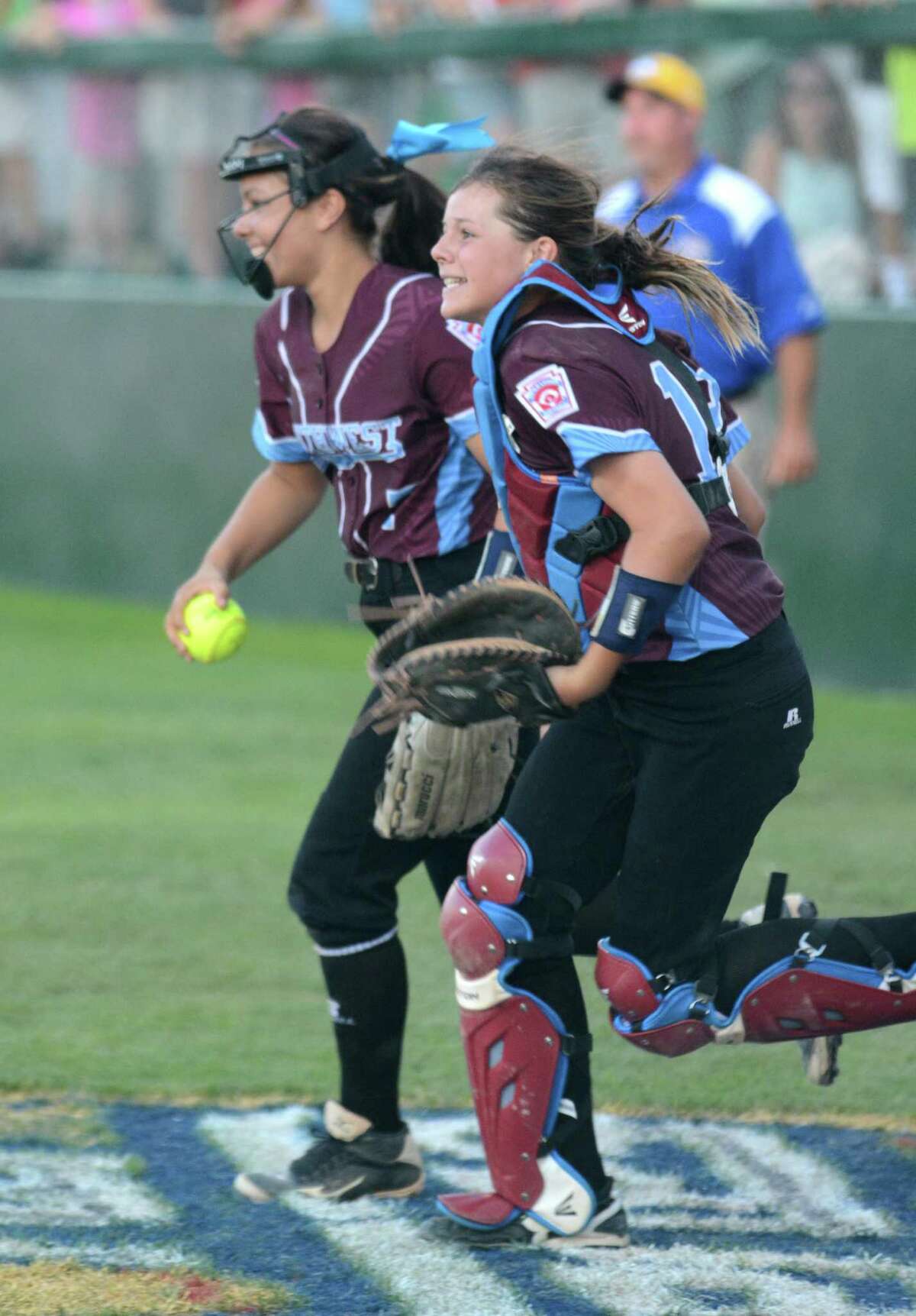 Teammates Maddie McKay and Jackie Kirkpatrick return from foul territory after McKay caught a pop-up in front of the Rowan dugout for the final out in Wednesday's championship game.