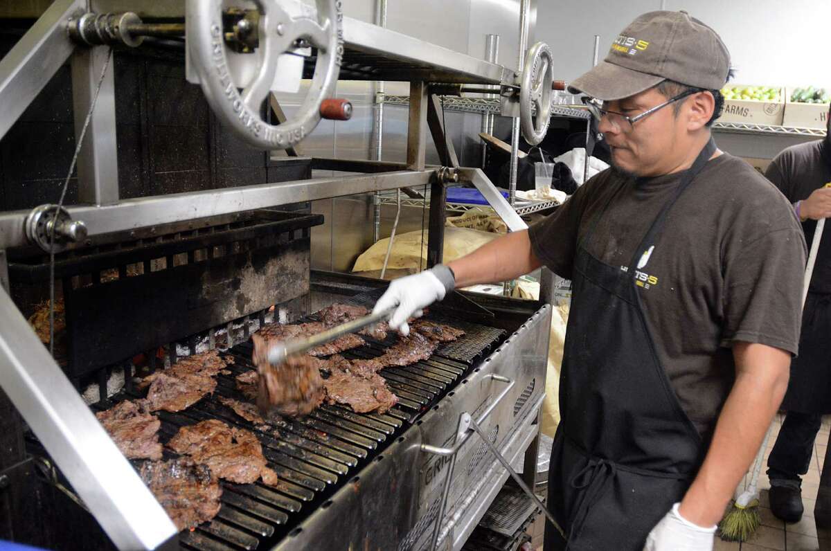 Houston Chef Estban Tipaz prepares beef on the grill for the lunch crowd. Cattle raisers have emerged from the drought years a few years ago but are now dealing with an oversupply of especially fat animals.