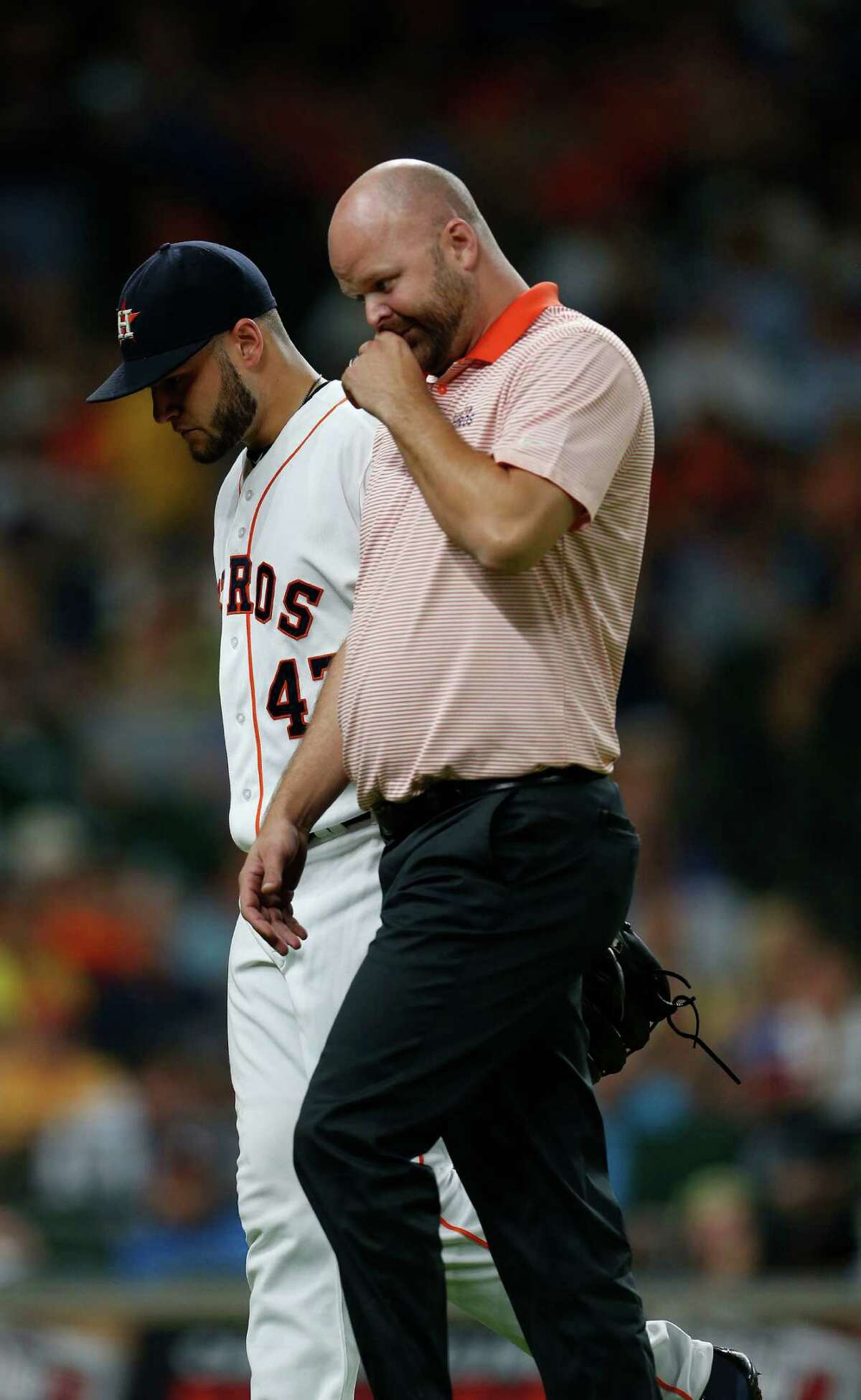 Houston Astros starting pitcher Lance McCullers (43) walks back to the dugout with trainer James Ready during the fifth inning of an MLB game at Minute Maid Park, Tuesday, Aug. 2, 2016, in Houston.