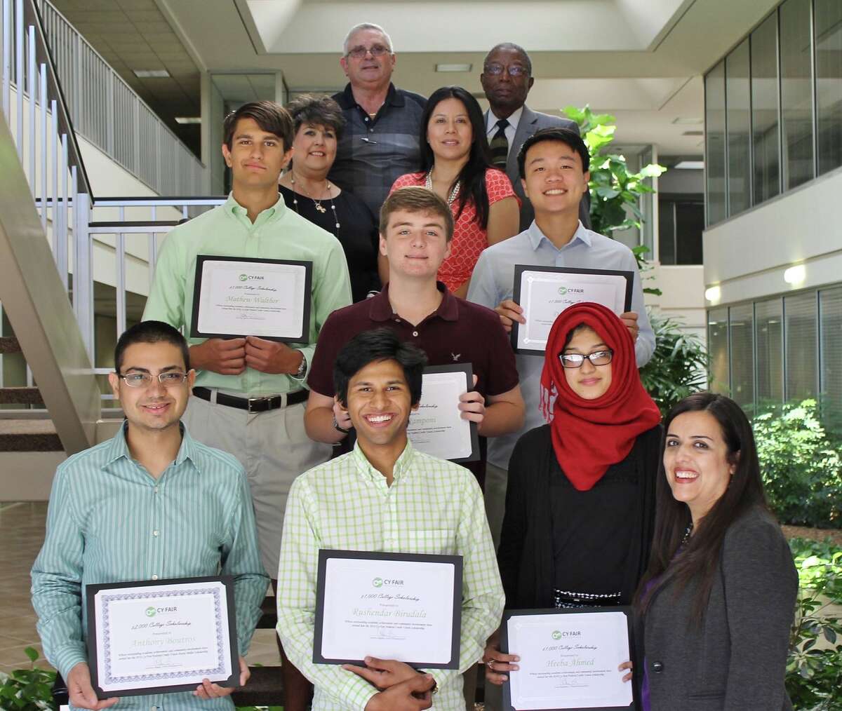 Cy-Fair Federal Credit Union representatives congratulate the 2016 winners of its scholarship program. In front are scholarship winners Anthony Boutros, left, Rushendar Birudala and Heeba Ahmed; and credit union employee Georgette Salazar. In the second row are scholarship winners Mathew Walther, left, Alex Ramponi and David Zhou. In the third row are scholarship committee members Alice Wimberly, left, and Celina Lapidus. Behind them are scholarship committee members Tony Barcelona III, left, and Isiah Spikes.