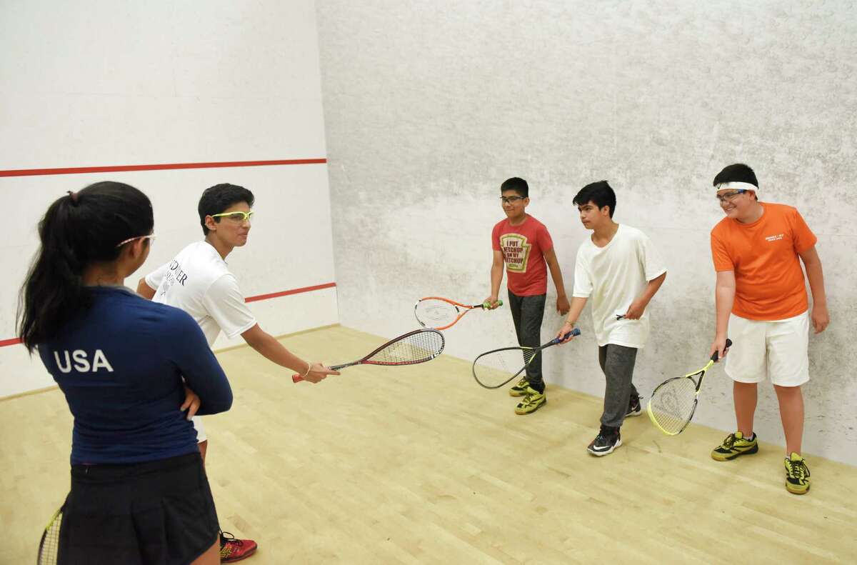 Greenwich kids Prianca and Ishaan Patel, far left, ages 15 and 16, teach squash to Bronx 12-year-olds, from left, Billy Mendez, Edward Diaz, and Alexander Garces at the New York Sports Clubs squash courts in Stamford, Conn. Wednesday, Aug. 3, 2016. Greenwich siblings Ishaan and Prianca Patel, ages 16 and 15, started a non-profit program called SquasherKids to educate lower and middle school students through squash and other educational and fun activities.