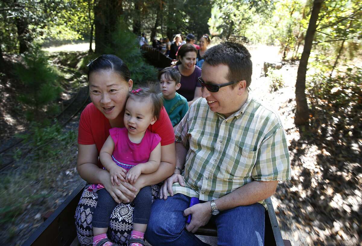 Hannah Estes, 1, takes a ride through Tilden Park aboard the Redwood Valley Railway with her mom Orawan Techachoocherd and dad Micah Estes in Orinda, Calif. on Wednesday, Aug. 3, 2016.