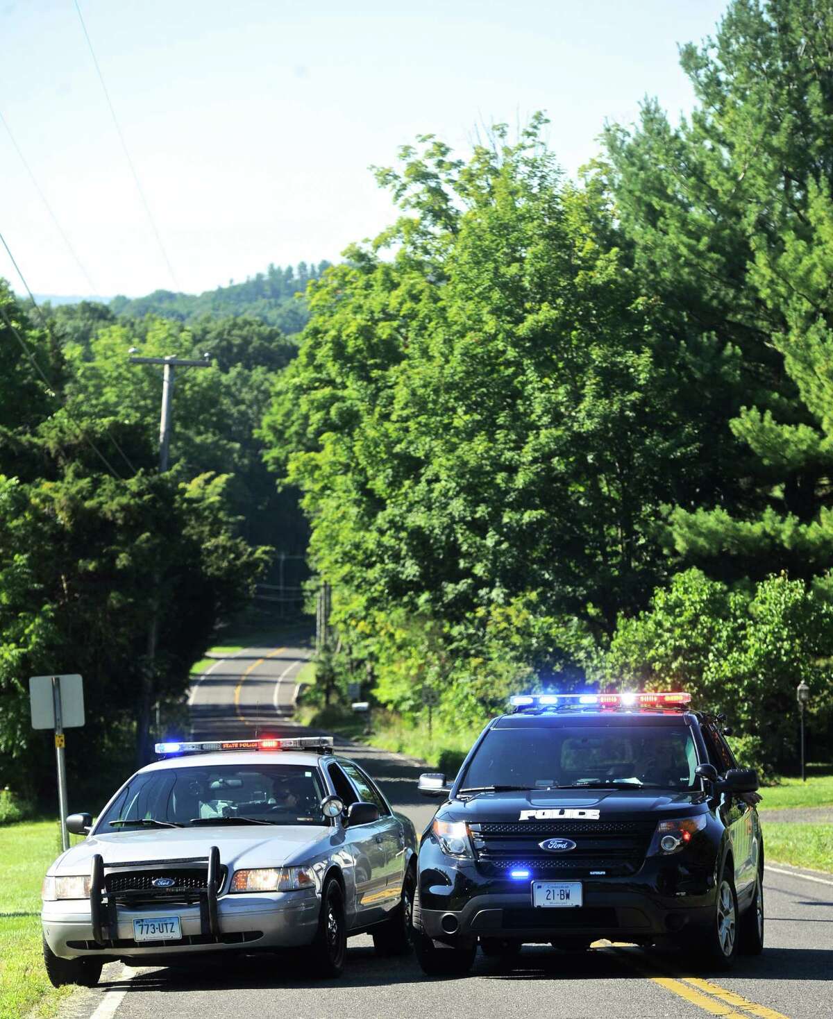 A state trooper and local police close off Rte 133 at the intersection of Main Street S ( Rte 133) and Stuart Road E and Stuart Road W, in Bridgewater. Main Street S was close traffic because of an investigation into a reported shooting and home invasion early Thursday morning. August, 4, 2016, in Bridgewater, Conn. Rte 133 is also closed to thru traffic because of scheduled construction.