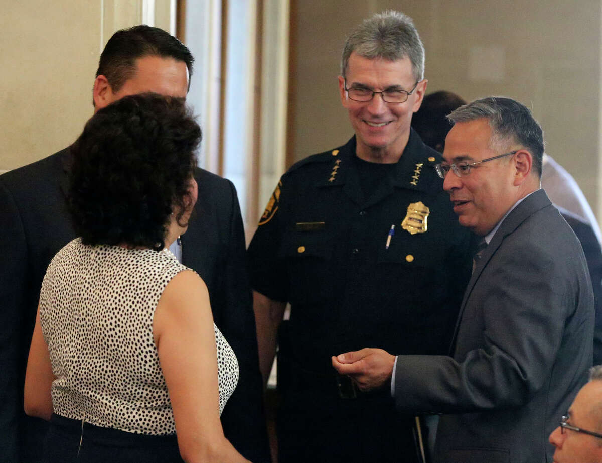 San Antonio's new city attorney Andrew Segovia (right) speaks with police chief William McManus (second from right) and others during a city council meeting Thursday August 4, 2016. Segovia was a lawyer for General Motors and is originally from San Antonio.