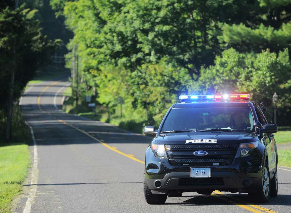 Local police close off Rte 133 at the intersection of Main Street S ( Rte 133) and Stuart Road E and Stuart Road W, in Bridgewater. Main Street S was close traffic because of an investigation into a reported shooting and home invasion early Thursday morning. August, 4, 2016, in Bridgewater, Conn. Rte 133 is also closed to thru traffic because of scheduled construction.