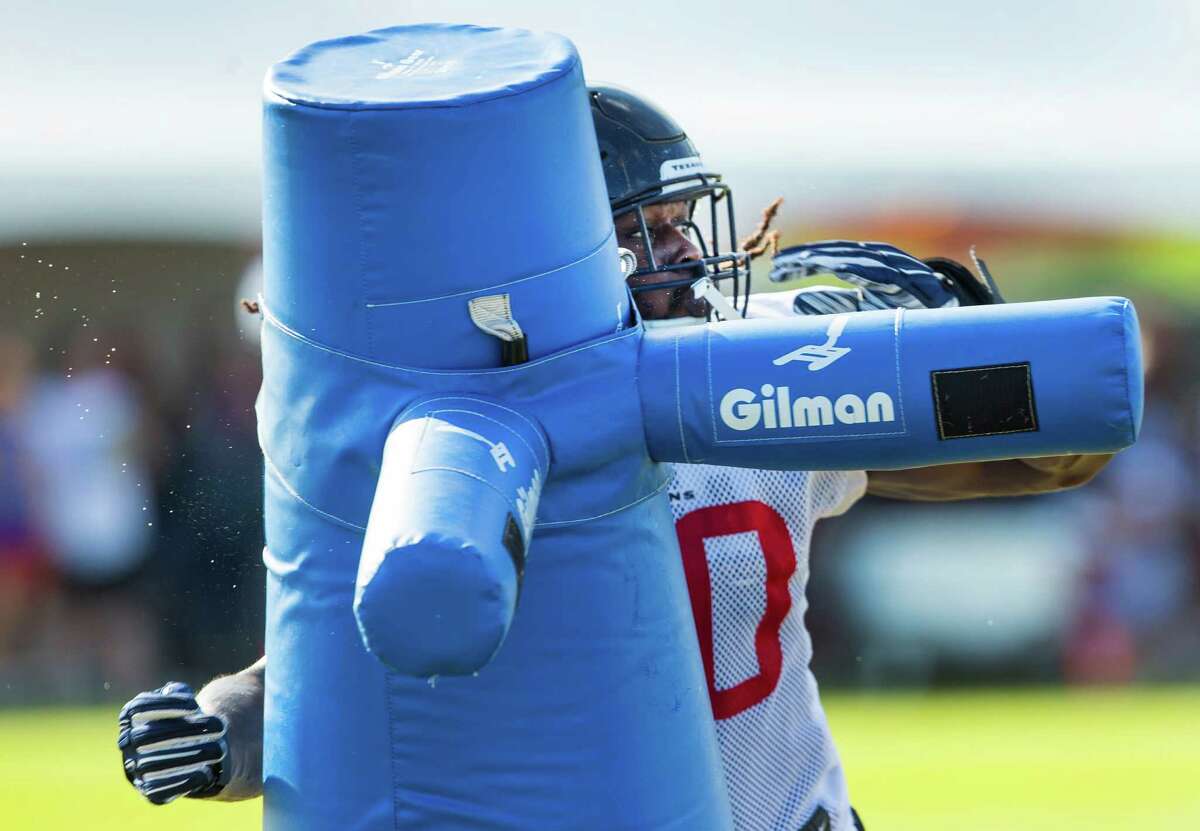 Houston Texans outside linebacker Jadeveon Clowney hits a blocking dummy during a pass rush drill during Texans training camp at Houston Methodist Training Center on Thursday, Aug. 4, 2016, in Houston.