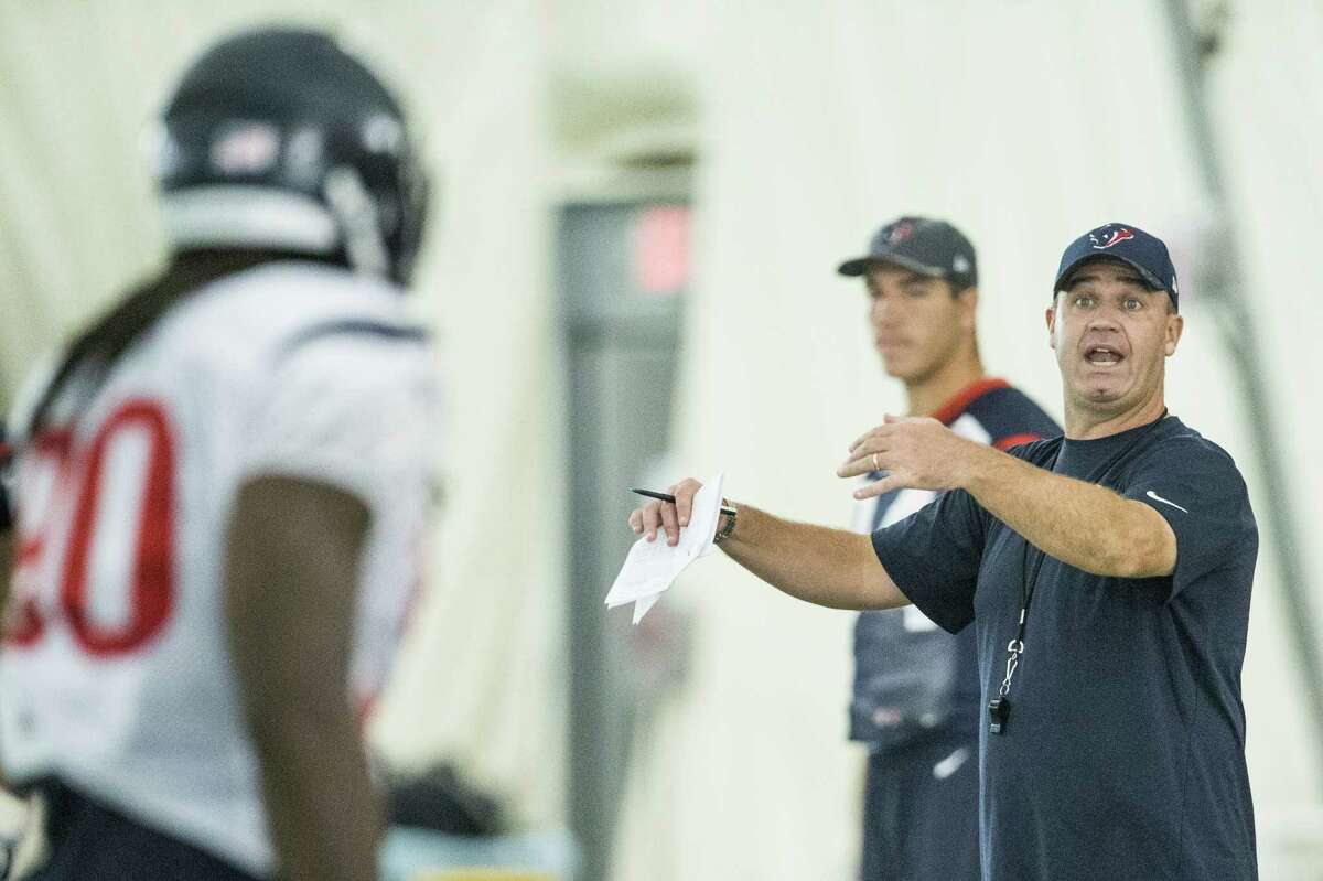 Houston Texans head coach Bill O'Brien talks to outside linebacker Jadeveon Clowney (90) during a special teams drill at Texans training camp at Houston Methodist Training Center on Wednesday, Aug. 3, 2016, in Houston.