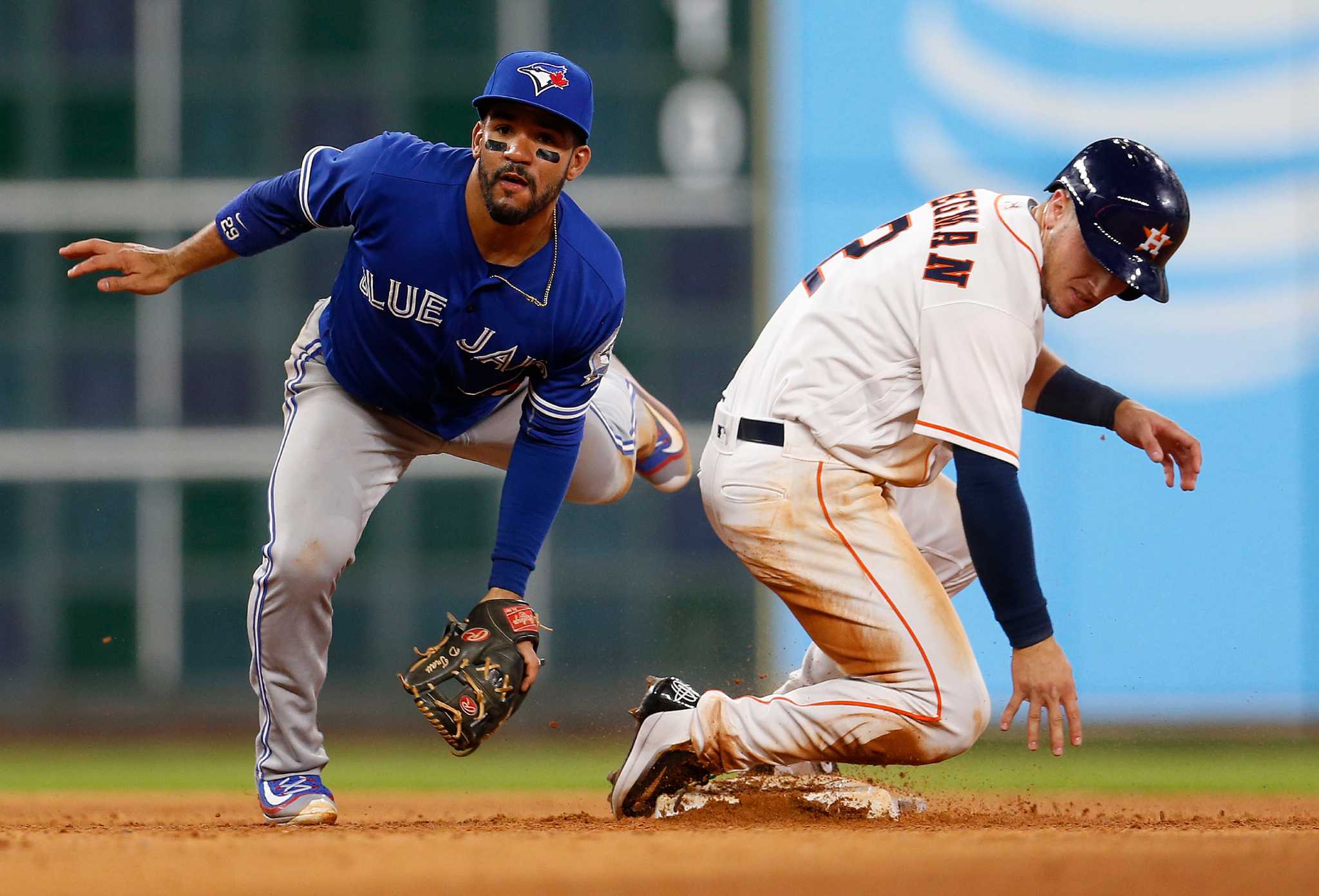 Houston Astros' Jose Altuve, centre, is celebrates with Carlos Correa,  right, and George Springer after hitting a two-run home run off Toronto  Blue Jays starting pitcher J.A. Happ (not shown) during second