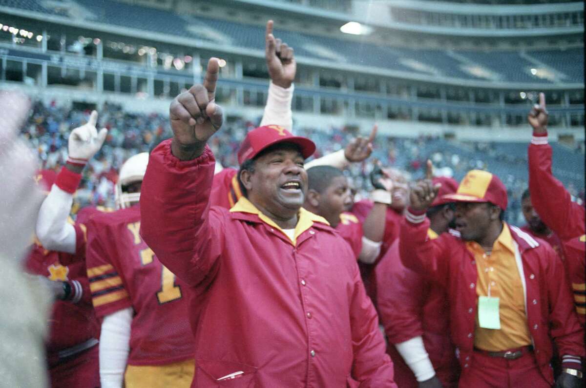 12/21/1985 - Coach Luther Booker and his Yates Lions celebrate their state title as the final seconds tick off the clock at the Class 5A state high school football championship between Yates and Odessa Permian in Texas Stadium. The final score, 37-0.