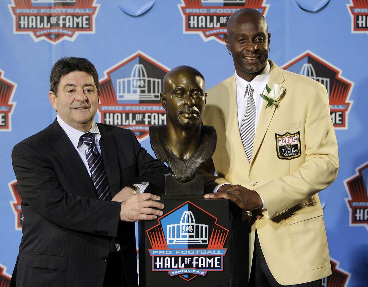 Former San Francisco 49ers great Jerry Rice, right, poses with former 49ers owner Eddie DeBartolo Jr. after Rice's enshrinement in the Pro Football Hall of Fame in Canton, Ohio Saturday, Aug. 7, 2010. (AP Photo/Mark Duncan)