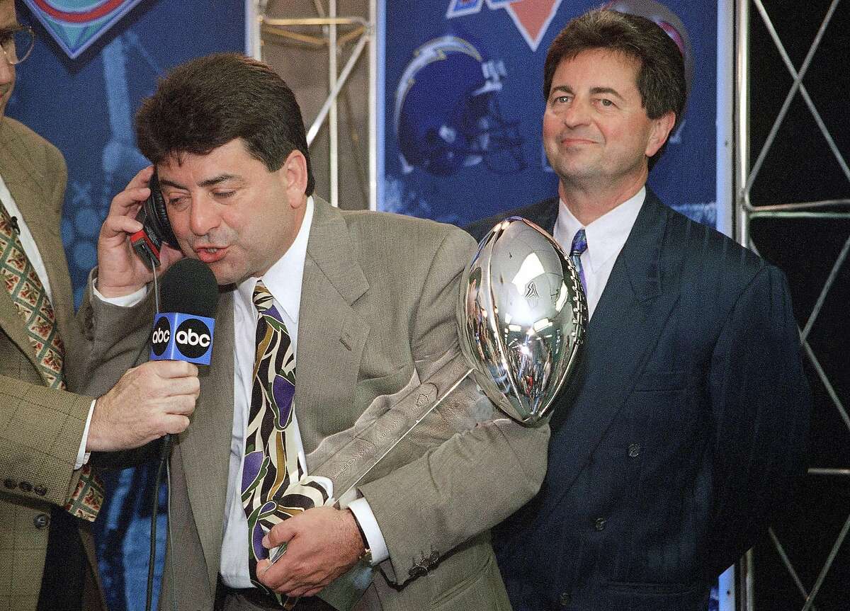 FILE - In this Jan. 29, 1995, file photo, San Francisco 49ers owner Eddie DeBartolo Jr. talks to President Clinton as he holds the Lombardi trophy after his team defeated the San Diego Chargers 49-26 to win Super Bowl XXIX in Miami. DeBartolo, the former football owner who guided the 49ers to greatness in the 1980s and 90sm now raises Clydesdales while operating his Florida commercial development business from afar. He also offers football guidance from a distance, mentoring nephew and 49ers CEO Jed York when asked or needed. (AP Photo/Eric Riseberg)