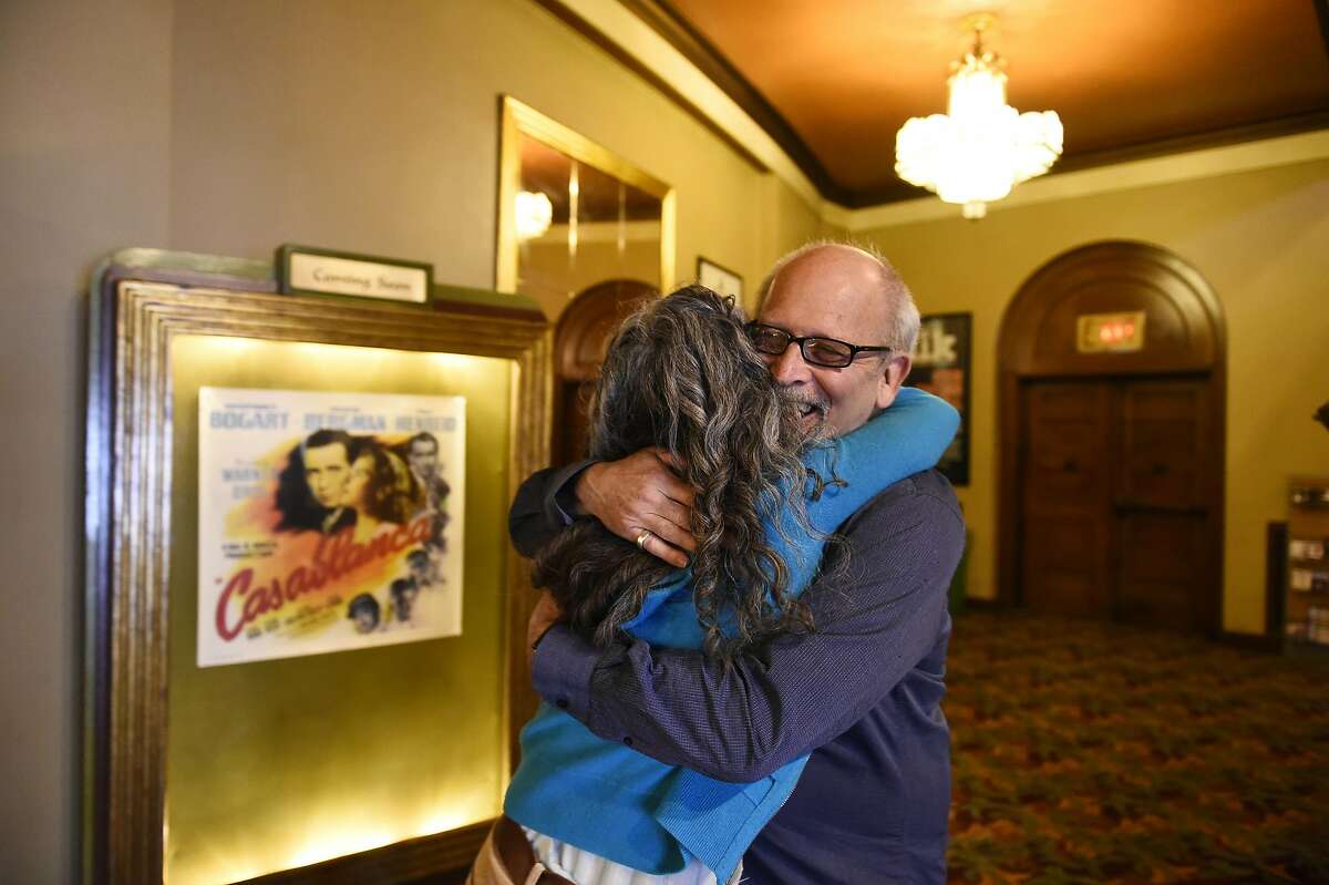 Elliot Lavine, the longtime creator of film programs at both the Roxie and the Castro, hugs longtime friend Jennifer Miko of San Franscisco before he takes part in a farewell show on Tuesday, August 3, 2016 in San Francisco, California.