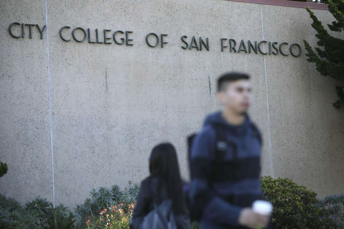 People walk past a sign for City College of San Francisco at the Ocean Campus on Monday, November 16, 2015 in San Francisco, Calif.