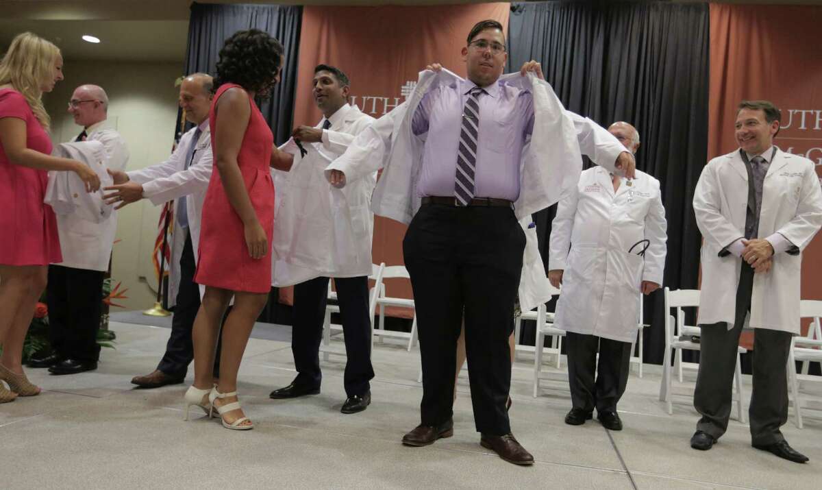 McGovern Medical School at UTHealth first-year students participate in the white coat ceremony to kick off their medical school career on Thursday, July 28, 2016, in Houston.