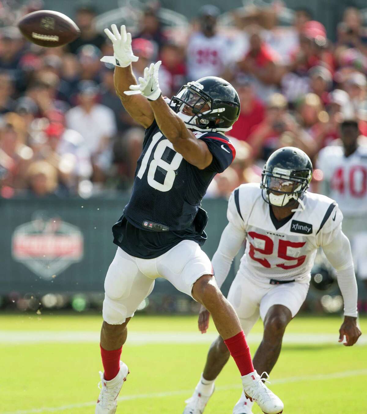Houston Texans wide receiver Cecil Shorts (18) reaches up to make a catch witih cornerback Kareem Jackson (25) defending during Texans training camp at Houston Methodist Training Center on Saturday, Aug. 6, 2016, in Houston.