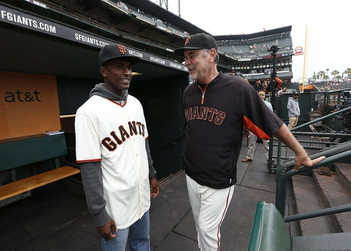 Lucius Fox, shown meeting with the media and with Giants manager Bruce Bochy, visited AT&T Park on Wednesday, July 8, 2015. Fox signed a $6 million contract with the Giants, the largest deal the team has ever given to an international draft pick (Fox is from the Bahamas).