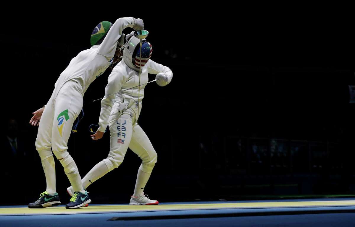 Kelley Hurley of the United States, right, and Nathalie Moellhausen of Brazil compete in the women's individual epee event at the 2016 Summer Olympics in Rio de Janeiro, Brazil, Saturday, Aug. 6, 2016. (AP Photo/Andrew Medichini)