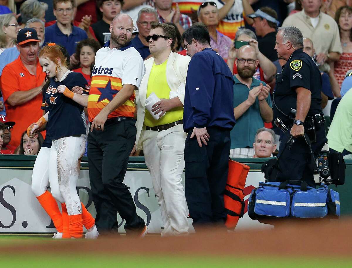 A member of the Shooting Stars is aided after being run over by the buggy carrying Orbit during the sixth inning of an MLB game at Minute Maid Park, Saturday, Aug. 6, 2016, in Houston. Browse through the photos to see some of the strangest things that have happened at Minute Maid Park.