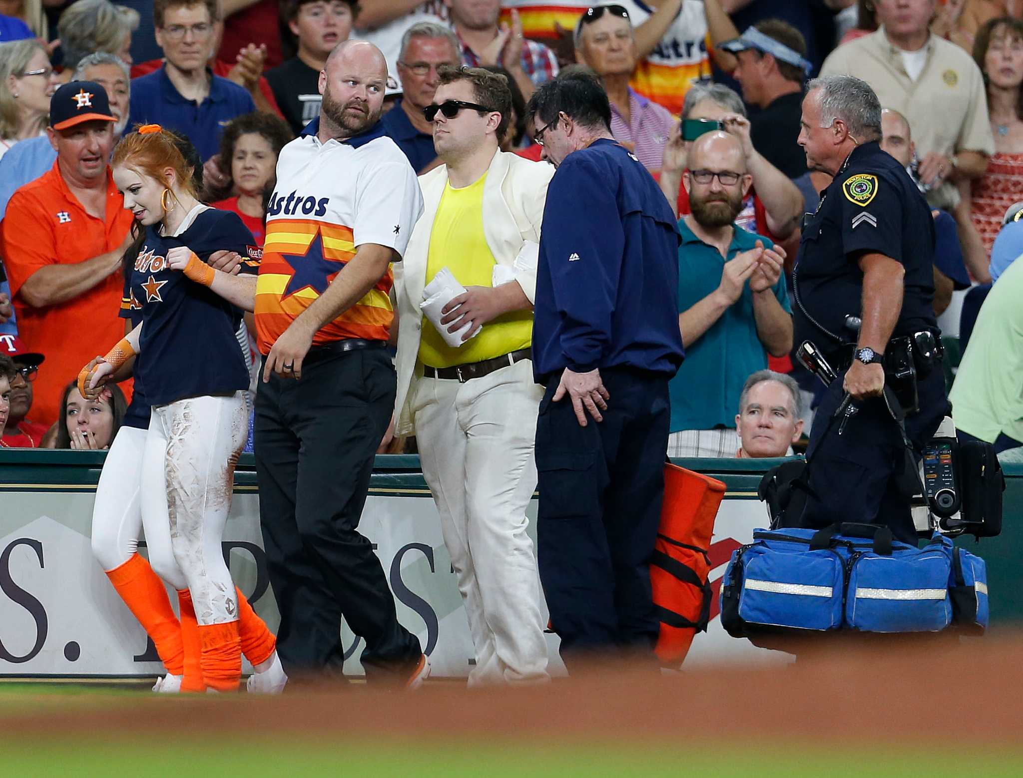 Houston Astros mascot Orbit leaps over a security employee while streaking  across the field in the