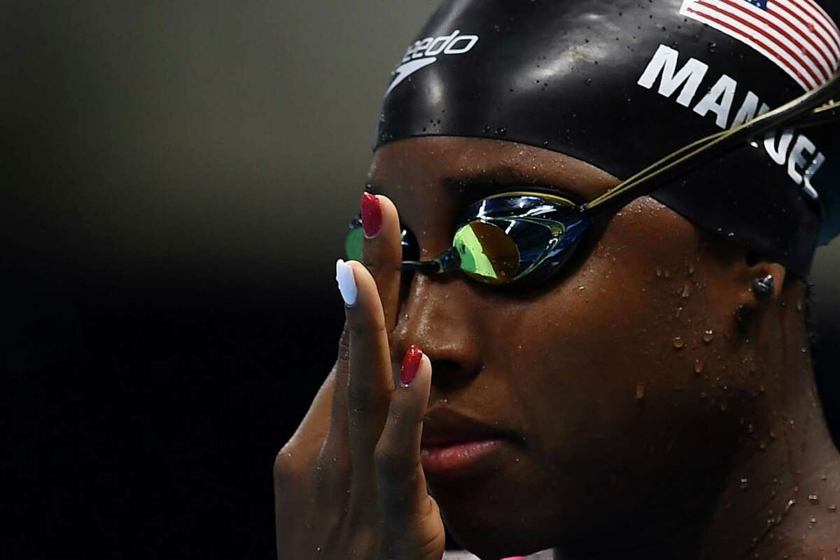 USA's swimmer Simone Manuel adjusts her glasses during a training session at the Olympic Aquatics Stadium ahead of the Rio 2016 Olympic Games in Rio de Janeiro on August 4, 2016. / AFP PHOTO / GABRIEL BOUYSGABRIEL BOUYS/AFP/Getty Images