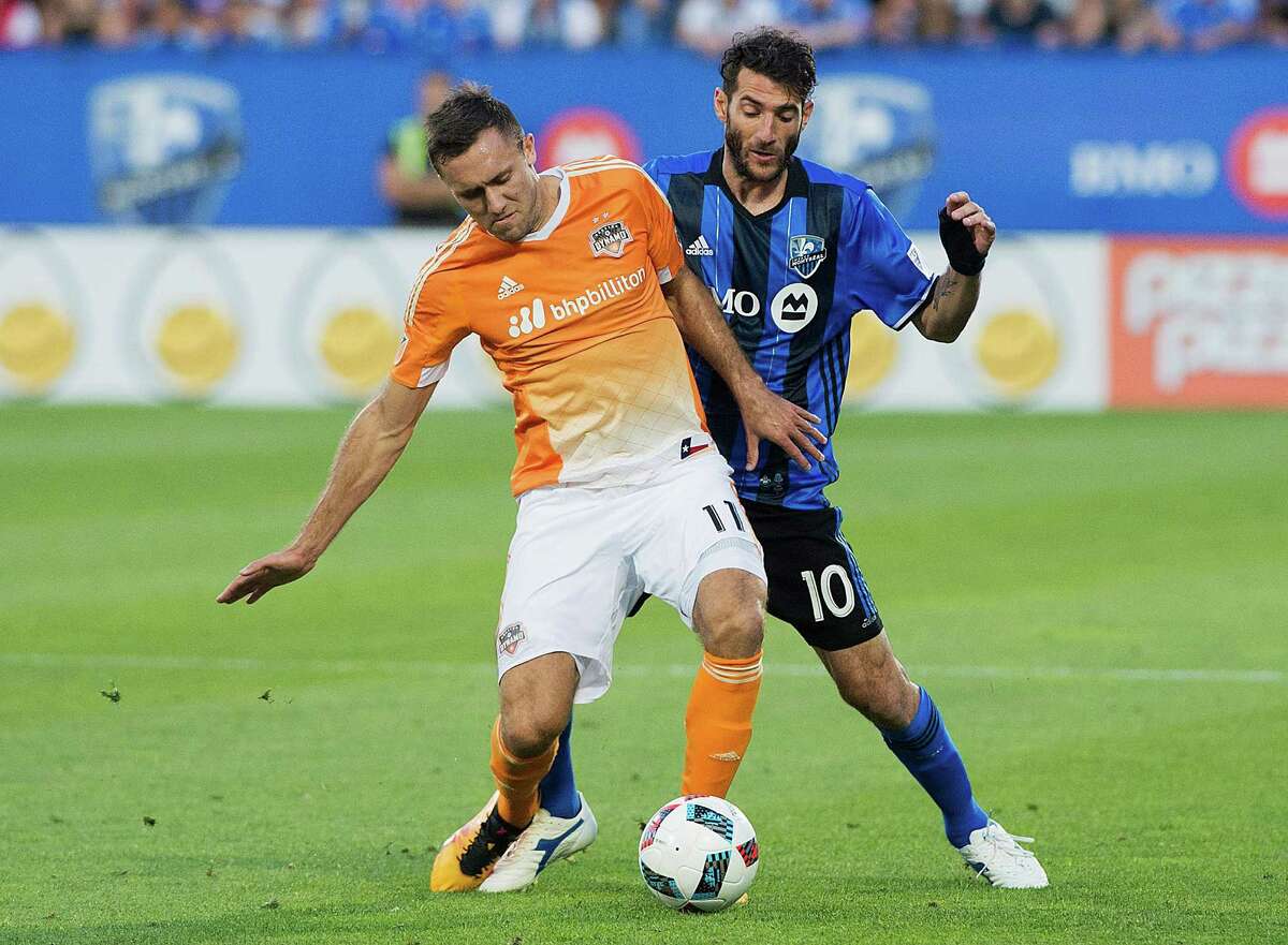 Montreal Impact's Ignacio Piatti (10) is challenged by Houston Dynamo's Andrew Wenger during first-half MLS soccer game action in Montreal, Saturday, Aug. 6, 2016. (Graham Hughes/The Canadian Press via AP)