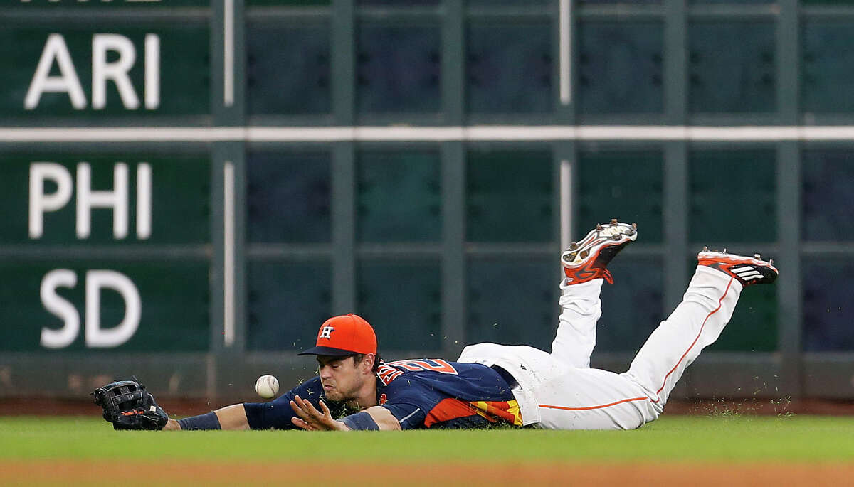 Houston Astros left fielder Preston Tucker (20) tries to catch a fly ball hit by Texas Rangers Rougned Odor during the fifth inning of an MLB game at Minute Maid Park, Sunday, Aug. 7, 2016, in Houston.