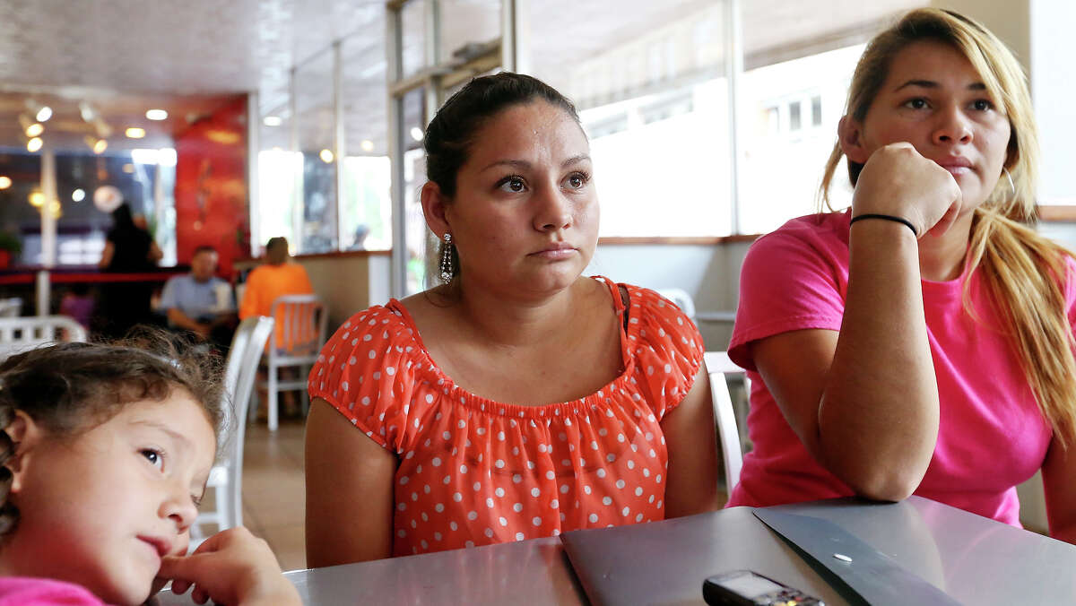 Nereida Eunice Ponce, 7, (from left), her mother Katherine Christel Ponce Osorio, 24, of El Salvador, and Roxana Maldonado, 21, of Honduras, are interviewed Friday June 12, 2015 at the San Antonio Greyhound bus station after being released from the Dilley detention center.