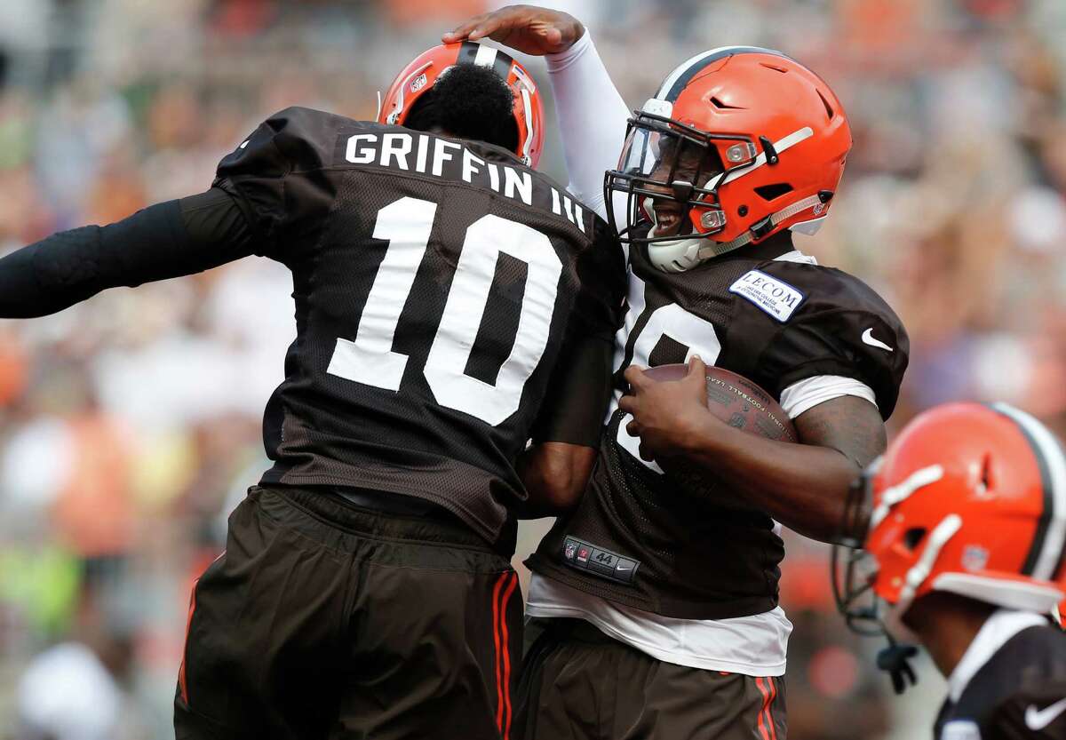 Cleveland Browns running back Duke Johnson, right, and quarterback Robert Griffin III celebrate a touchdown during their orange and brown scrimmage at the NFL football team's training camp Saturday, Aug. 6, 2016, in Columbus, Ohio. (AP Photo/Jay LaPrete)