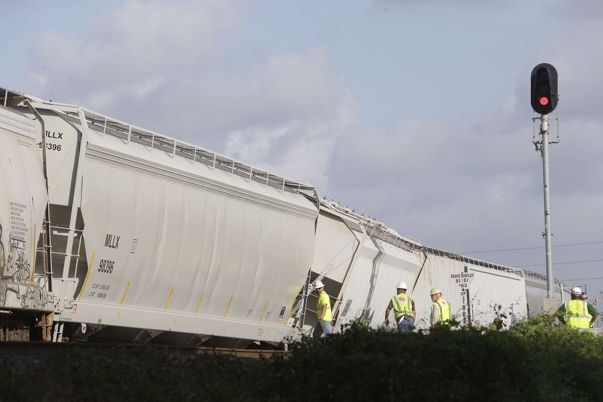 Officials are shown at a train derailment near Harbor Street and Clinton Drive, Monday, Aug. 8, 2016, in Houston. (Melissa Phillip / Houston Chronicle)