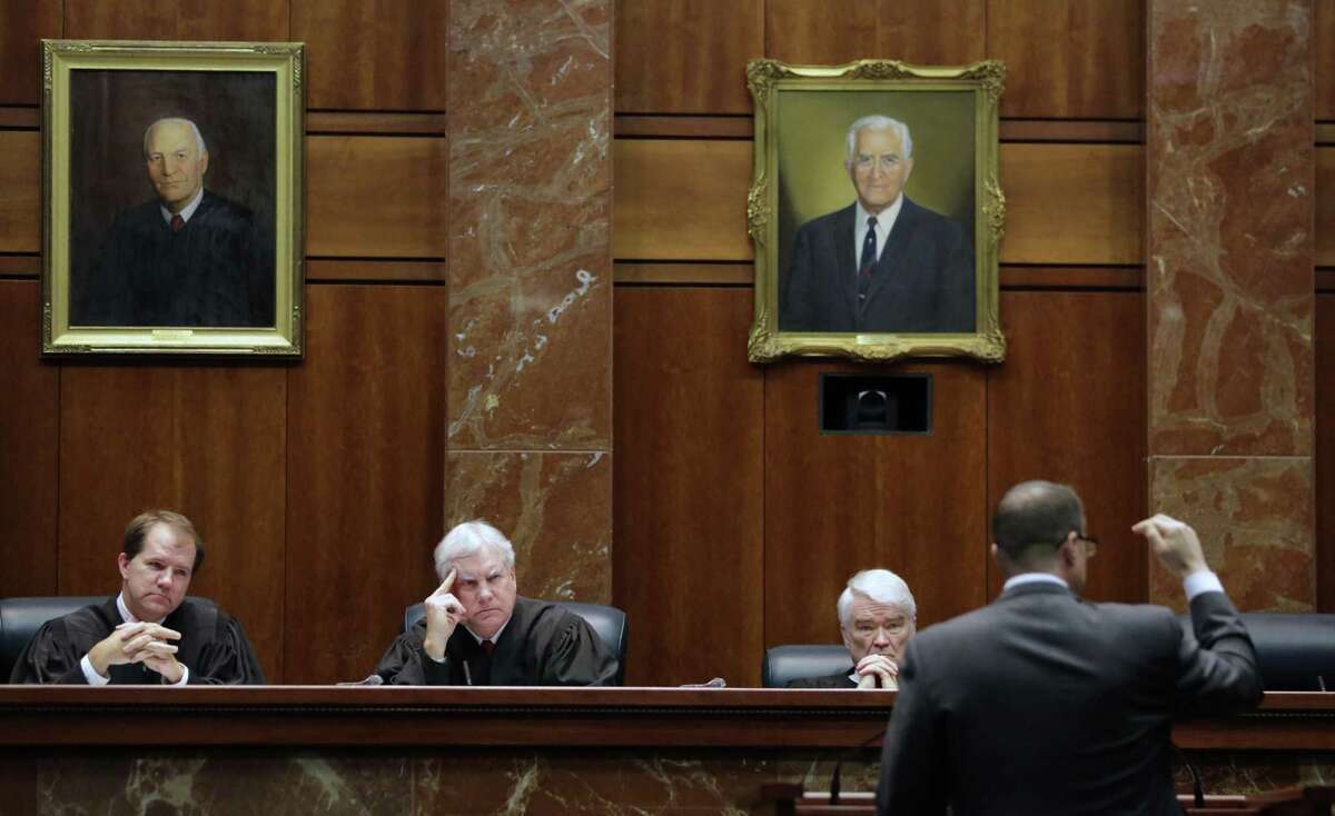 Texas Supreme Court justices, from left, Don Willett, Paul Green, and Nathan Hecht listen as attorney Chad Baruch argues in 2015 in a case for a home-schooling family in El Paso accused of failing to teach its kids anything because they were waiting for the second coming of Jesus Christ. A lawsuit now alleges that electing the court’s justices statewide, rather than by district, violates the Voting Rights Act because it all but guarantees Anglos will win. (AP Photo/Eric Gay)