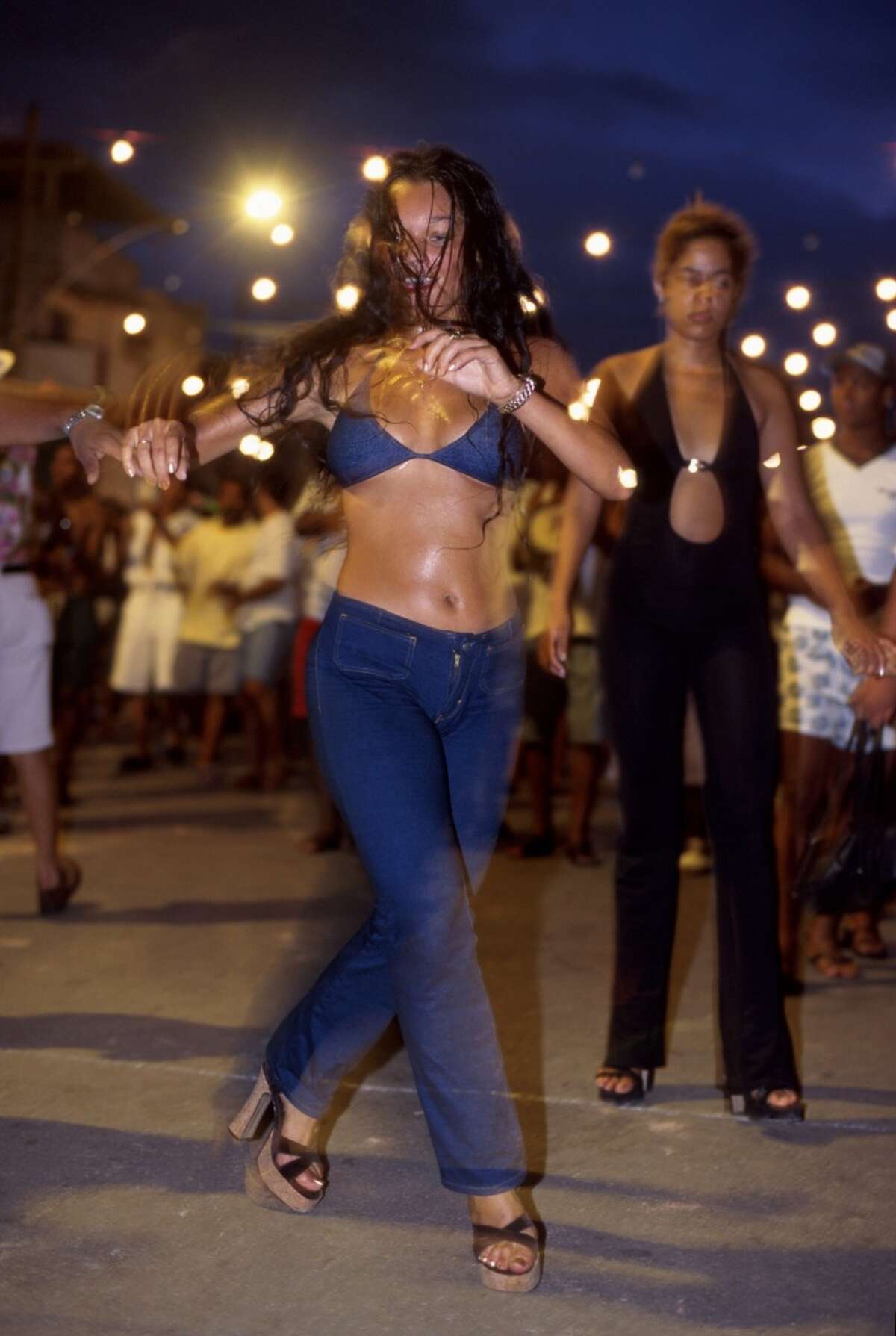 Young and beautiful women dance and have fun in front of Mangueira Samba School headquarter.
