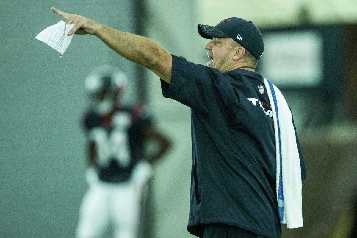 Houston Texans head coach Bill O'Brien makes a call on the field during Texans training camp at Houston Methodist Training Center on Monday, Aug. 8, 2016, in Houston.