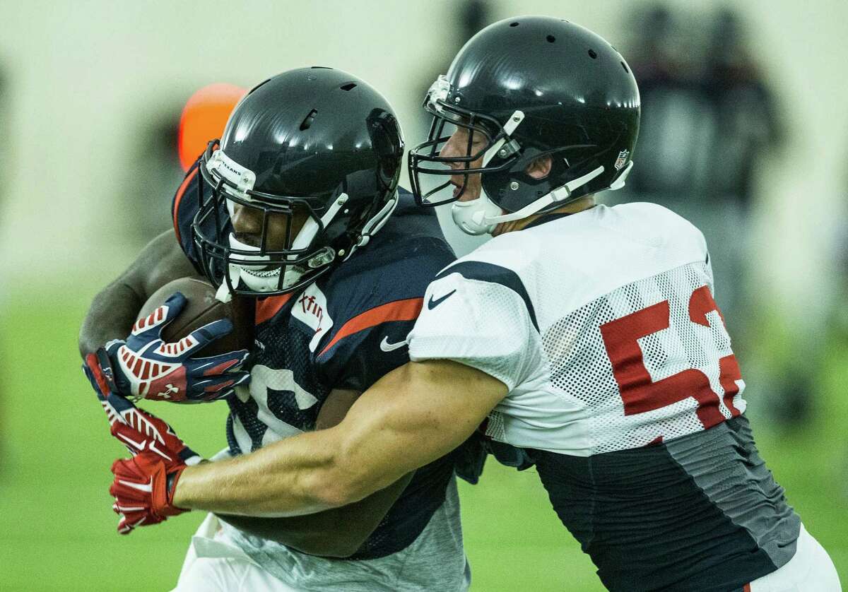 Houston Texans running back Lamar Miller, left, runs upfield against linebacker Brian Peters (52) after a reception during Texans training camp at Houston Methodist Training Center on Monday, Aug. 8, 2016, in Houston.