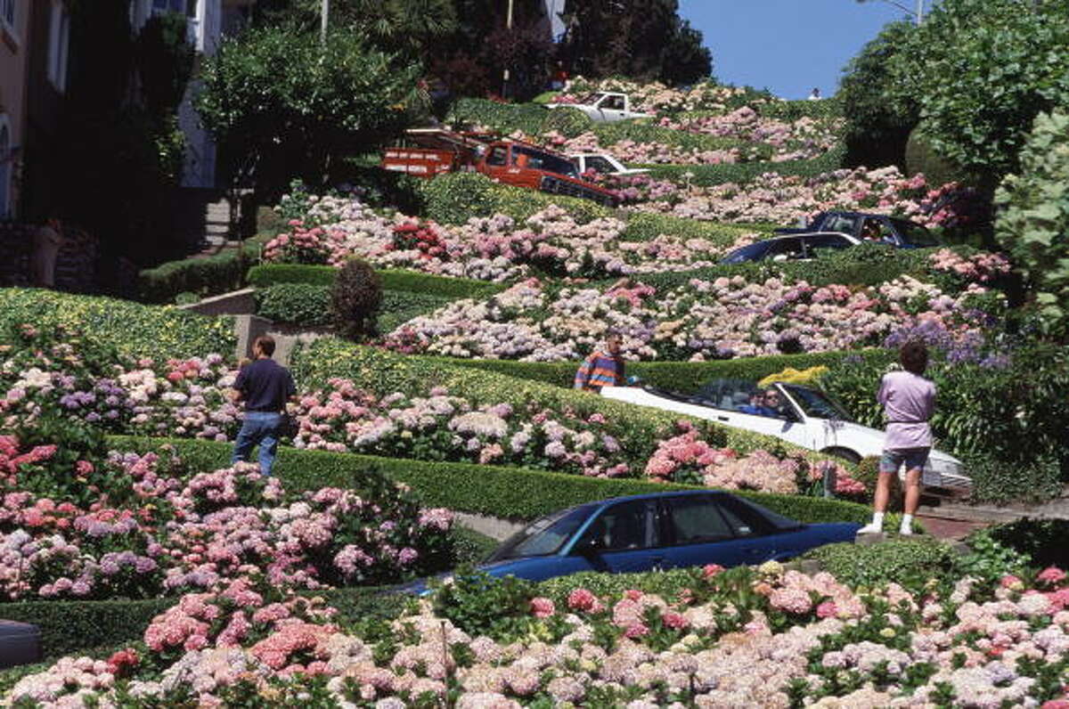 Flower beds in full bloom as they follow the twists and turns of Lombard Street (Photo by Bob Thomas/Popperfoto/Getty Images)