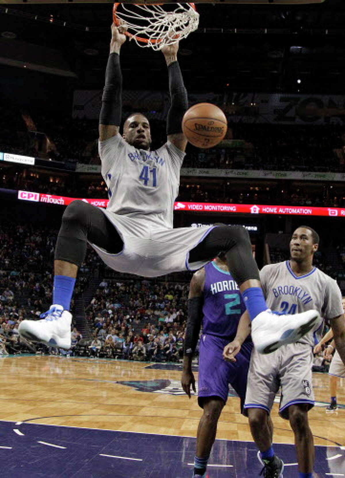 Brooklyn Nets' Thomas Robinson (41) dunks against the Charlotte Hornets in the second half of an NBA basketball game in Charlotte, N.C., Friday, April 8, 2016. The Hornets won 113-99. (AP Photo/Chuck Burton)
