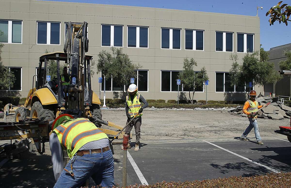The parking lot of the Stanford's future library is resurfaced on Thursday, August 4, 2016, in Redwood City, Calif. The library will be part of a 35-acre campus purchased from Stanford in 2005 for its new campus housing medical clinics, offices, and research development space for 2400 employees.