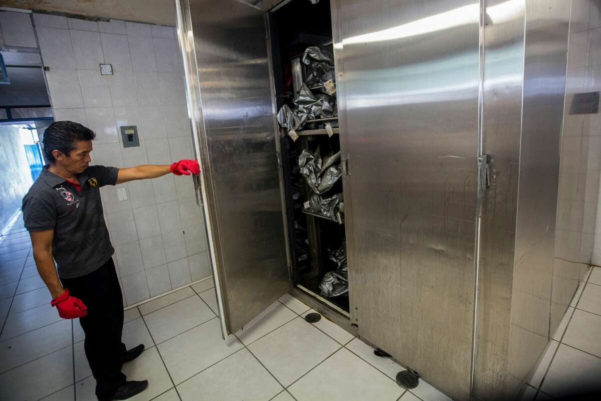 A forensic staffer shows the morgue's cold chambers full of body bags in Acapulco, Mexico on July 13, 2016. With a population of 810,000 the touristic resort of Acapulco ranks as one of the most violent cities in the world, with a crime rate of 111 murders per 100,000 inhabitants in 2015.