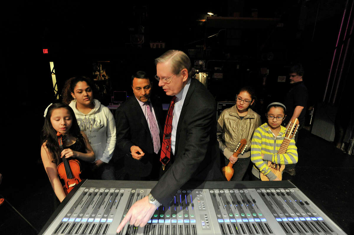 Harman Chairman, President and CEO Dinesh Paliwal shows Mayor David Martin a digital mixing board as they are flanked by INTAKE music students during the INTAKE organization's education session with people from audio equipment manufacturer Harman at the Palace Theatre in Stamford, Conn., on Monday, March 16, 2015.
