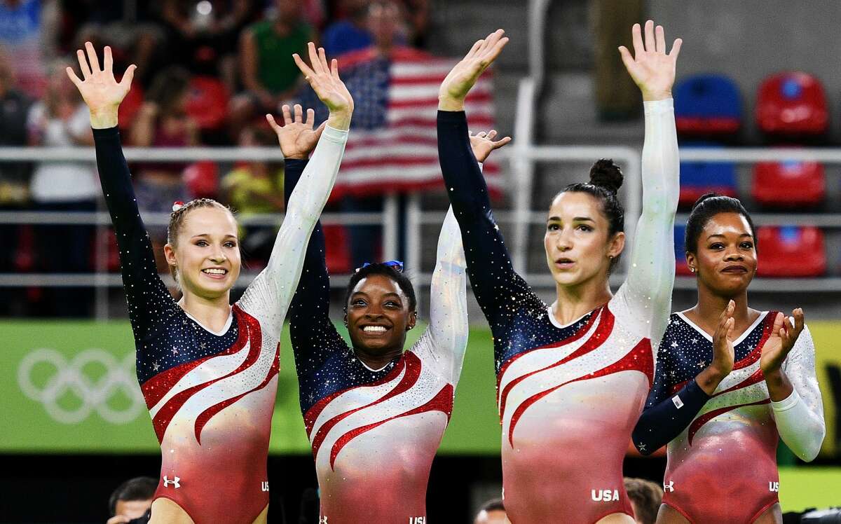 RIO DE JANEIRO, BRAZIL - AUGUST 09: (L to R) Madison Kocian, Simone Biles, Alexandra Raisman and Gabrielle Douglas of the United States celebrate winning the gold medal during the Artistic Gymnastics Women's Team Final on Day 4 of the Rio 2016 Olympic Games at the Rio Olympic Arena on August 9, 2016 in Rio de Janeiro, Brazil. (Photo by David Ramos/Getty Images)