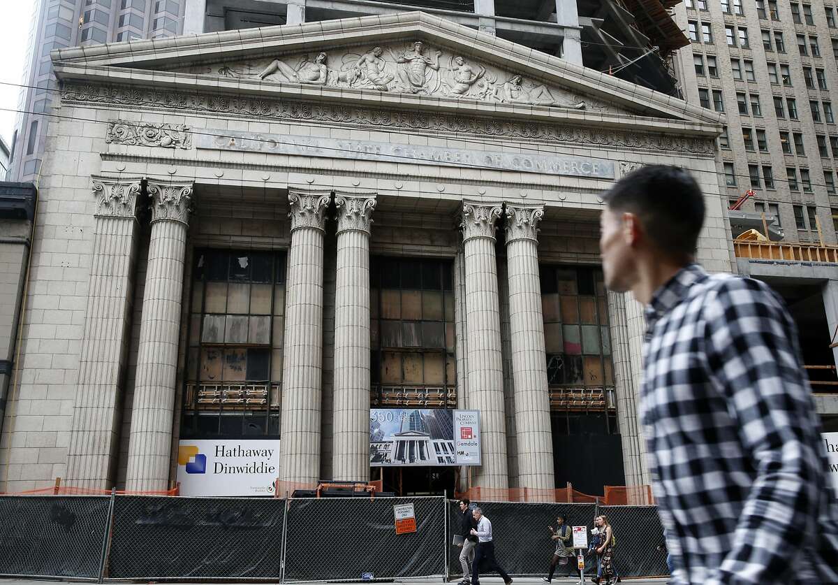 A man walks past the old Mining Exchange Building at 350 Bush Street where construction on a 19-story office tower continues in San Francisco, Calif. on Friday, Aug. 5, 2016.