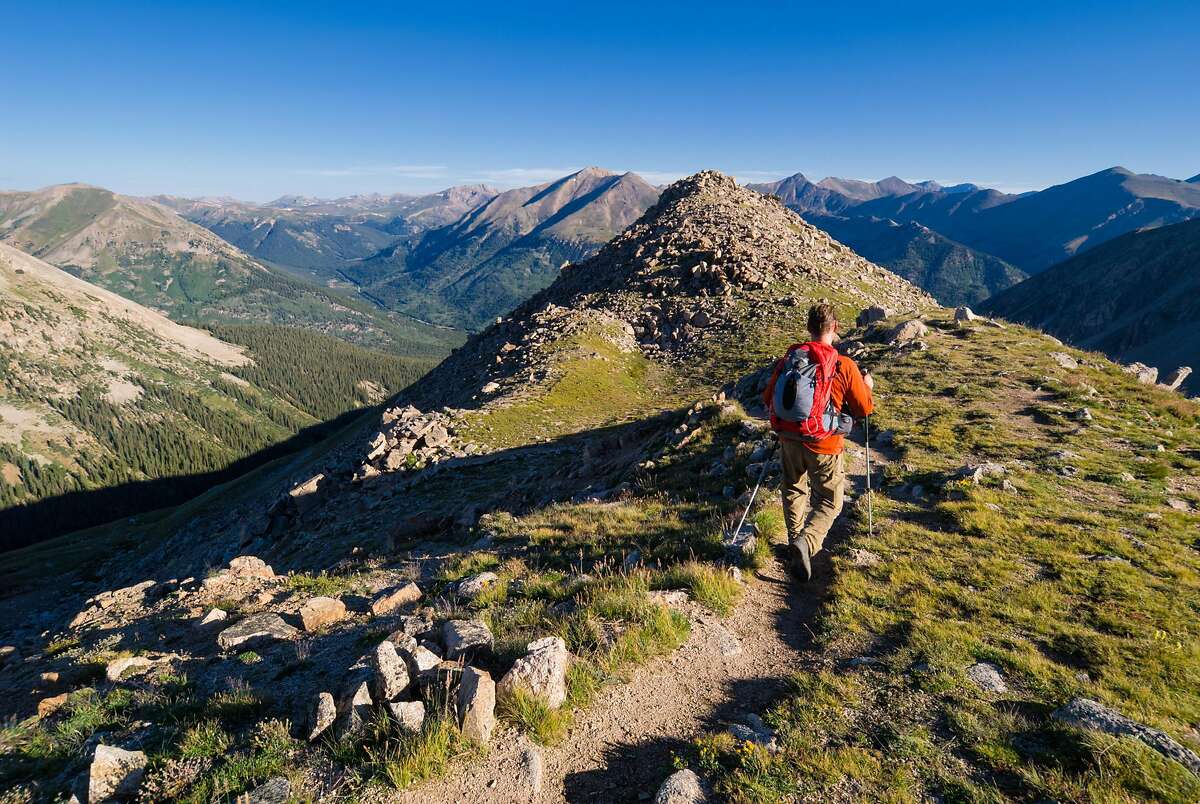 Man recreating and exploring along mountain ridge high in mountains. �LaPlata Peak, Sawatch Range, Colorado. �Captured as a 14-bit Raw file. Edited in 16-bit ProPhoto RGB color space.