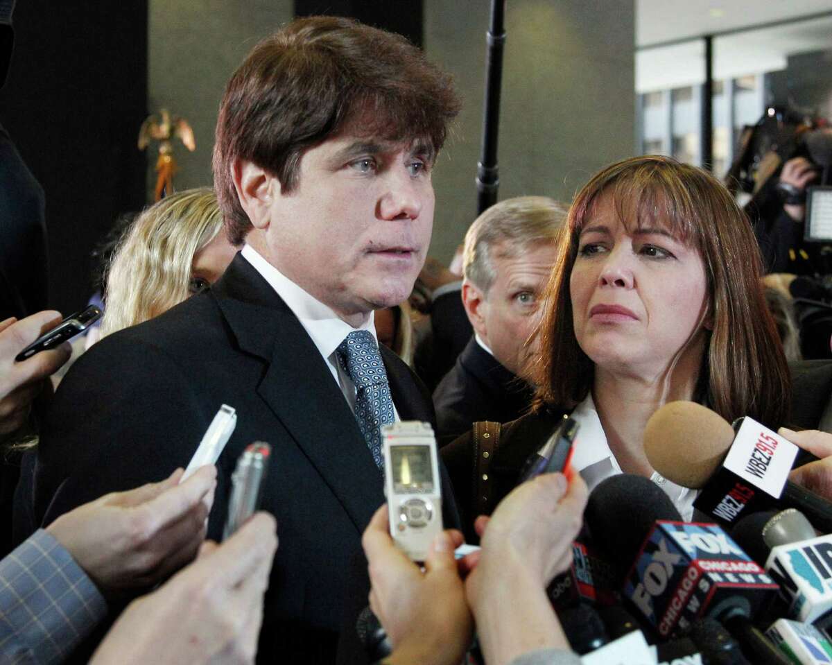 FILE - In this Dec. 7, 2011 file photo, former Illinois Gov. Rod Blagojevich, left, speaks to reporters as his wife, Patti, listens at the federal building in Chicago.A federal judge will decide Tuesday, Aug. 9, 2016, whether to cut the 14-year prison term given to Blagojevich after he was convicted of corruption, including charges that he tried to exchange an appointment to President Barack Obama's old U.S. Senate seat in exchange for campaign donations. (AP Photo/M. Spencer Green, File)