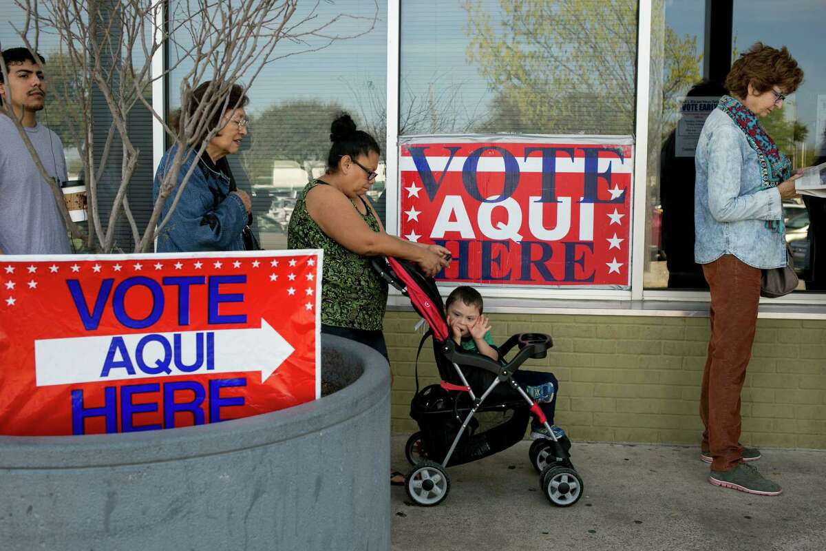 Marcelina Cavajal waits with son Anjelito Jaimes, 3, and other voters outside an Austin polling station in March.