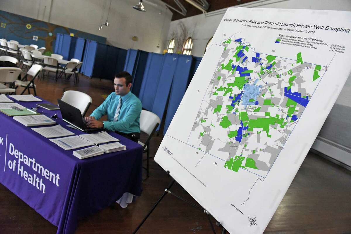 Adam Helman with the New York State Health Department Center for Environmental Health works a public information table to answer questions from the public on PFOA contamination at the Hoosick Falls Armory on Tuesday Aug. 9, 2016 in Hoosick Falls, N.Y. (Michael P. Farrell/Times Union)