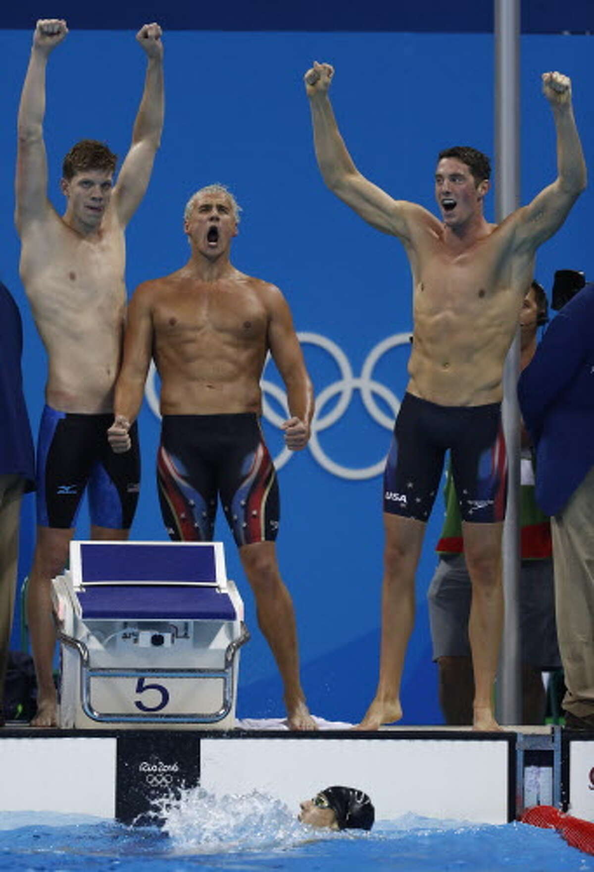 (From topL) USA's Townley Haas, USA's Ryan Lochte and USA's Conor Dwyer celebrate with USA's Michael Phelps (bottom) after they won the Men's 4x200m Freestyle Relay Final during the swimming event at the Rio 2016 Olympic Games at the Olympic Aquatics Stadium in Rio de Janeiro on August 9, 2016. / AFP PHOTO / Odd AndersenODD ANDERSEN/AFP/Getty Images