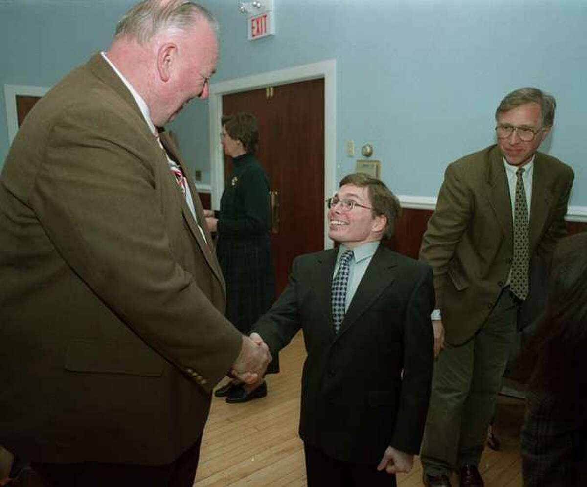 Marty Landgrebe,the new Probate Judge for New Milford, Conn., center is greeted by George Buckbee, after his swearing in at Town Hall, Tues. Jan. 5 1998.