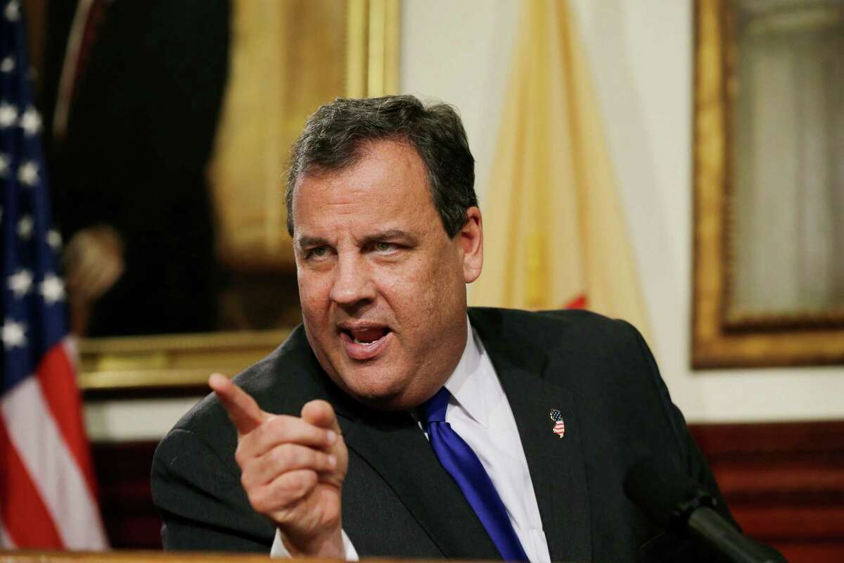 In this Dec. 13, 2013 photo, New Jersey Gov. Chris Christie reacts to a question during a news conference in Trenton, N.J., A former aide to Christie texted to a colleague that the New Jersey governor "flat out lied" during the news conference about the George Washington Bridge lane-closing scandal, according to a new court filing. (AP Photo/Mel Evans)