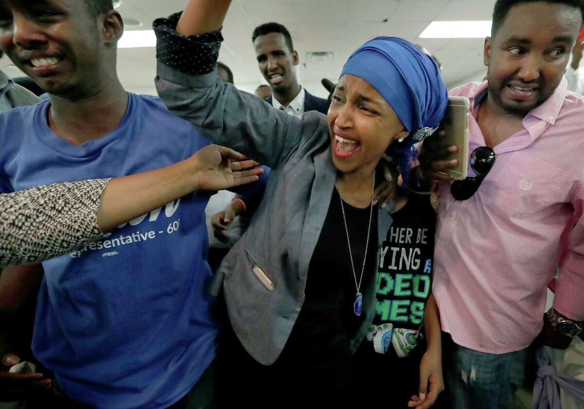 Somali activist Ilhan Omar is greeted by supporters at Kalsan Tuesday, Aug. 9, 2016, in Minneapolis. Omar defeated 22-term Rep. Phyllis Kahn in Tuesday's nominating contest in the heavily Democratic Minneapolis district. (Carlos Gonzalez/Star Tribune via AP)